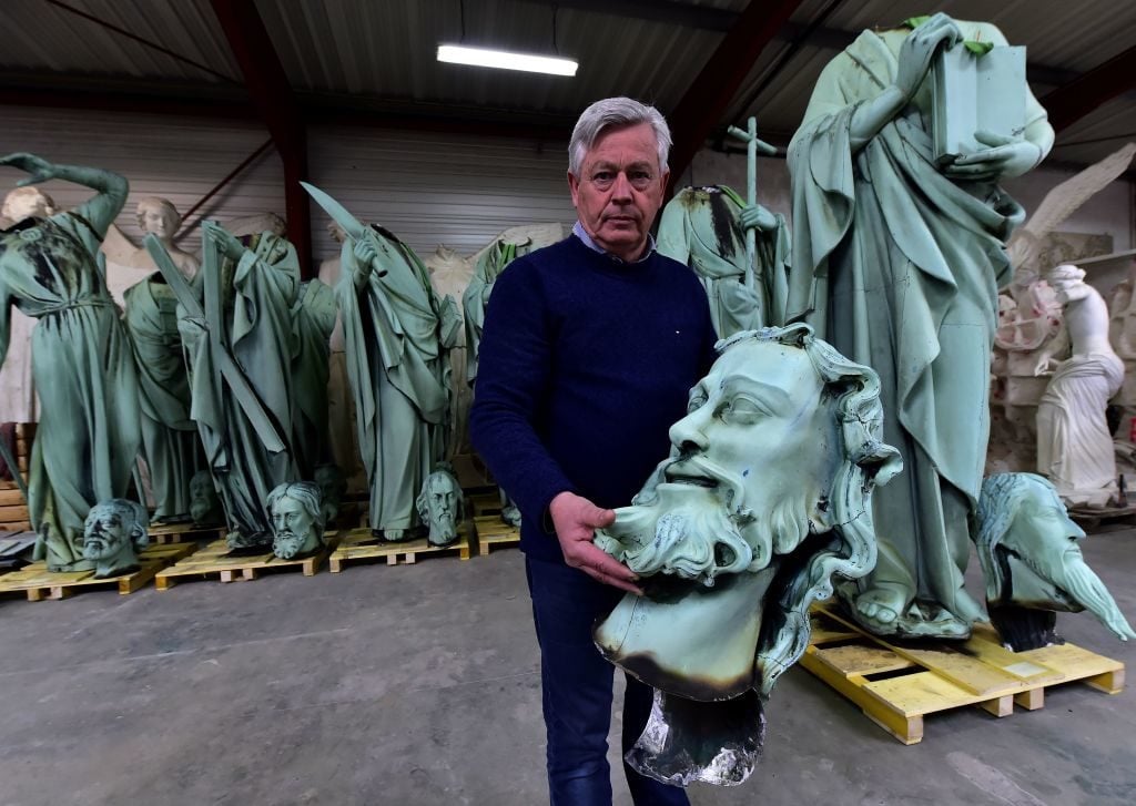 Patrick Palem, heritage restoration expert, shows the head of a one of the statues which sat around the spire of the Notre-Dame cathedral in Paris, stored in SOCRA workshop in Marsac-sur-Isle near Bordeaux. Photo by Georges Gobet/AFP/Getty Images.