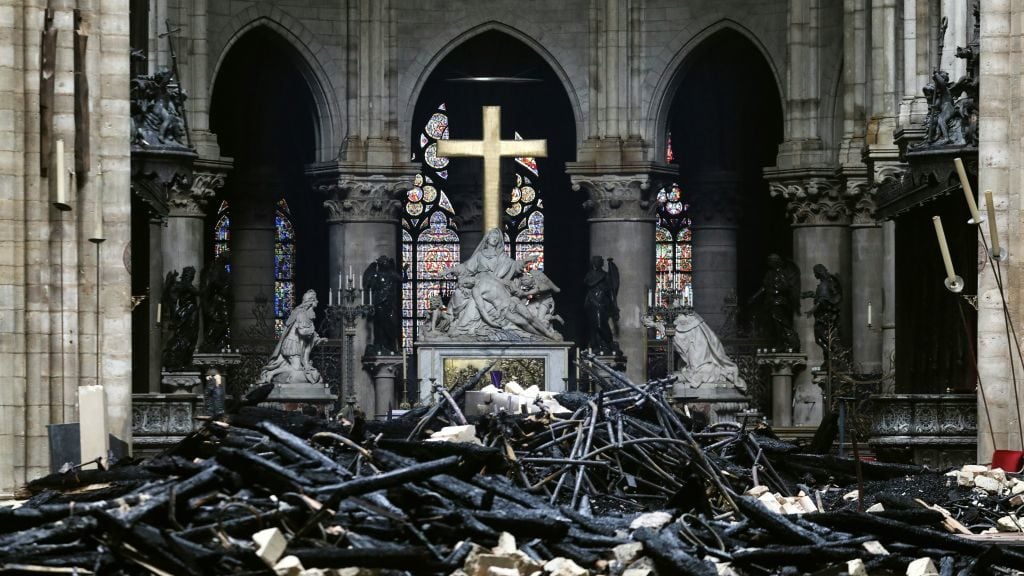 A picture taken on April 16, 2019 shows the altar surrounded by charred debris inside the Notre-Dame Cathedral in Paris. Photo by Ludovic Marin/AFP/Getty Images.