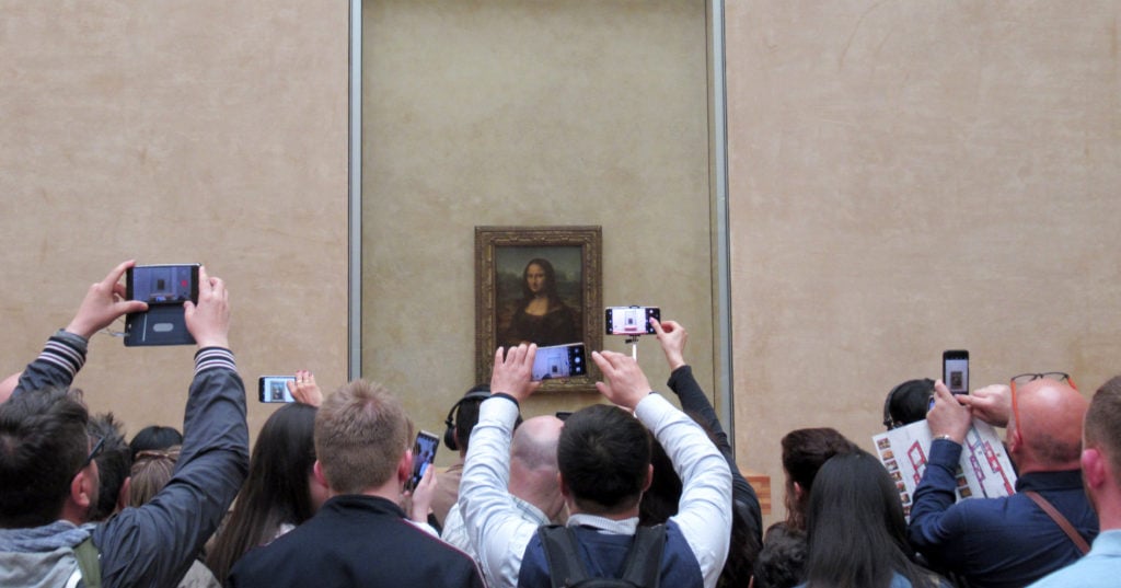 Visitors crowd around Leonardo da Vinci's Mona Lisa in the Louvre. Photo: Sabine Glaubitz/dpa/Getty Images.