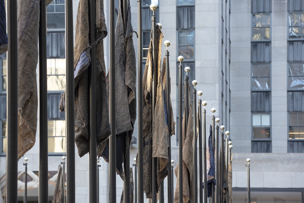 The flags by Ibrahim Mahama at Rockefeller Center. Image courtesy of the artist and Frieze.