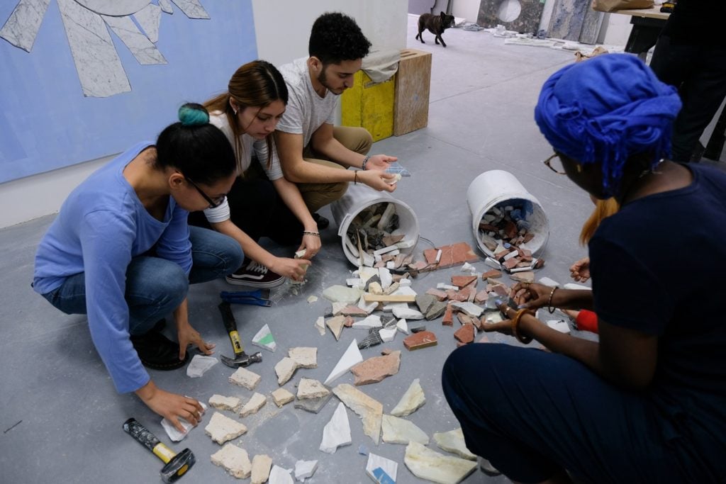 Free Arts teens selecting marble pieces for their project at Sam Moyer's studio. Photo courtesy of Free Arts.