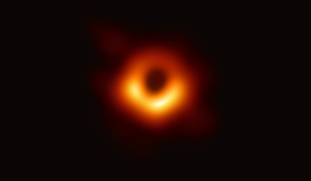 The Event Horizon Telescope— a planet-scale array of eight ground-based radio telescopes forged through international collaboration—was designed to capture images of a black hole. In coordinated press conferences across the globe, EHT researchers revealed that they succeeded, unveiling the first direct visual evidence of the supermassive black hole in the centre of Messier 87 and its shadow. The shadow of a black hole seen here is the closest we can come to an image of the black hole itself, a completely dark object from which light cannot escape. The image shows the light aroung black hole’s boundary, the event horizon. Image courtesy of the Event Horizon Telescope.