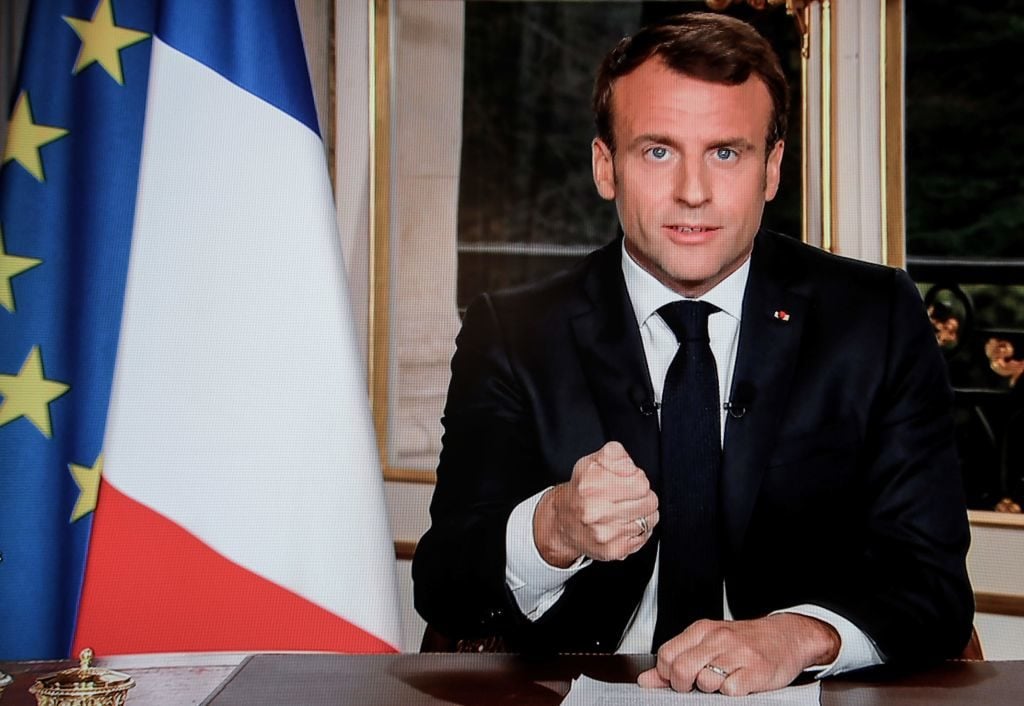 French President Emmanuel Macron addresses the nation on French private TV channel TF1, vowing to rebuild Notre-Dame de Paris Cathedral within five years. Photo courtesy Ludovic Marin/AFP/Getty Images.