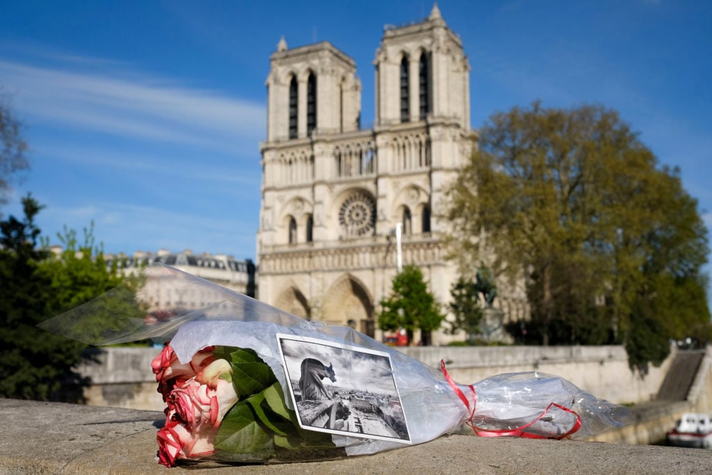 A bouquet of flowers is seen in front of the Notre Dame Cathedral in Paris, France, on April 17, 2019. Photo courtesy Xinhua/Alexandre Karmen via Getty Images.