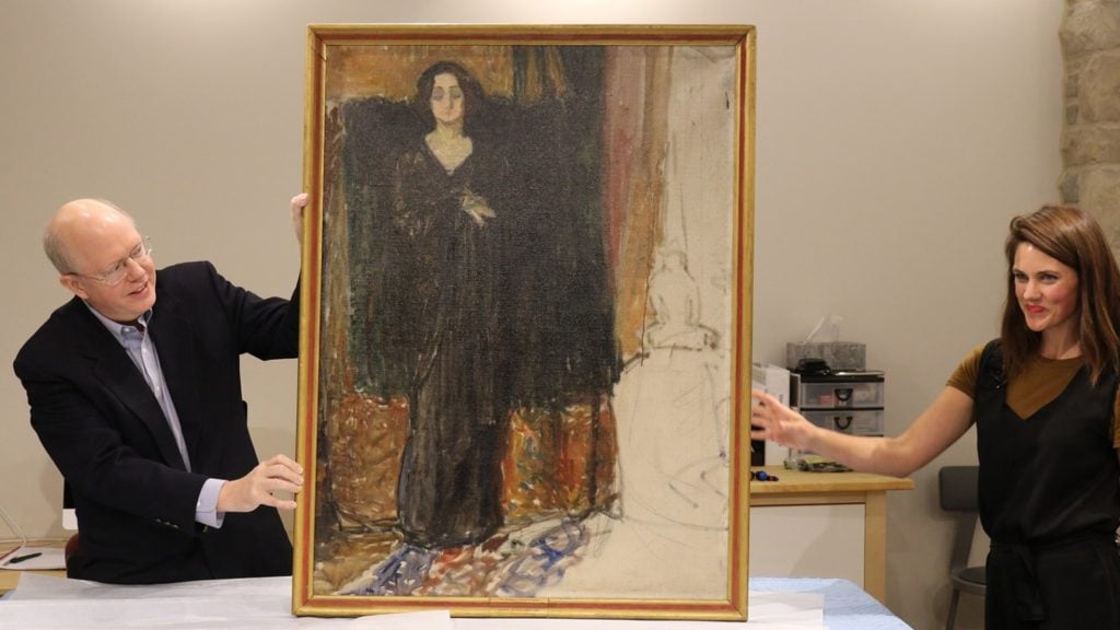 Adam Finnefrock of Scientific Analysis of Fine Art (left) and Flaten Art Museum Director Jane Becker Nelson ’04 (right) with Portrait of Eva Mudocci attributed to Edvard Munch. Photo by Will Cipos for the Flaten Museum of Art art St. Olaf's College.
