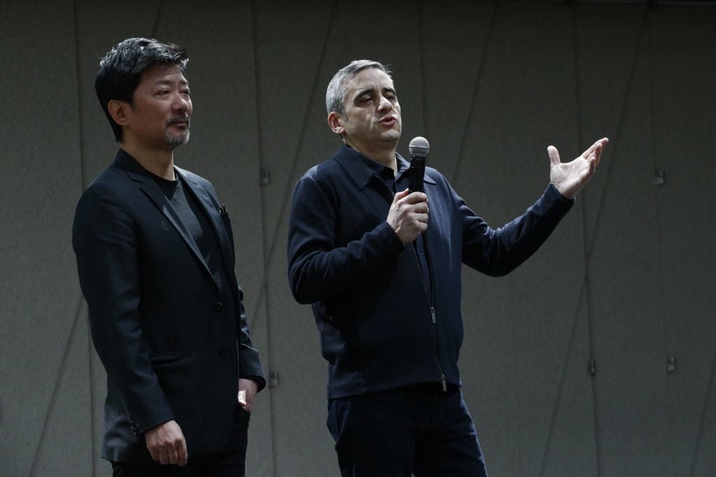 Alex Poots (right) speaks next to Chen Shi-Zenhg after the <em>Dragon Spring Phoniex Rise</em> rehearsal at the Tisch Skylights inside the new arts center The Shed Photo by Kena Betancur/AFP/Getty Images. 