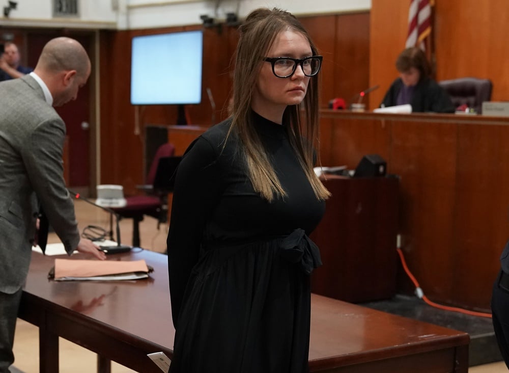 Fake German heiress Anna Sorokin is led away after being sentenced in Manhattan Supreme Court May 9, 2019 following her conviction last month on multiple counts of grand larceny and theft of services, her attorney Todd Spodek is seen left and Judge Diane Kiesel right. (Photo by TIMOTHY A. CLARY / AFP)