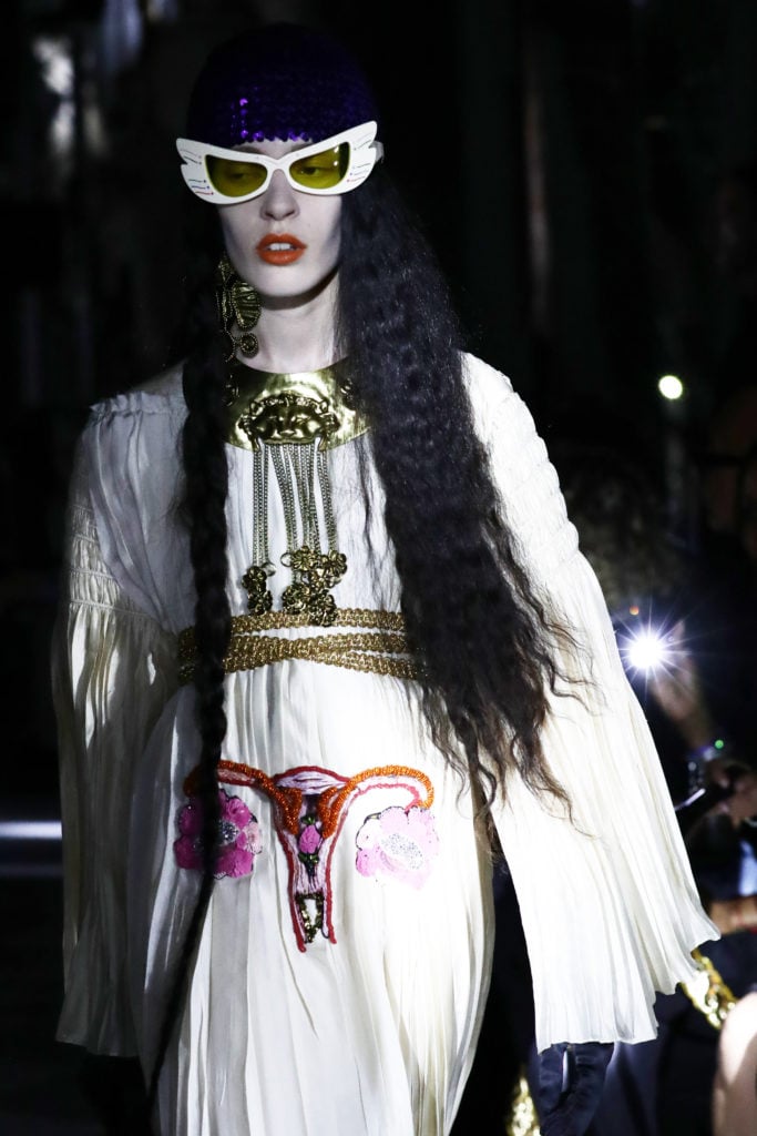 A white dress featured an embroidered uterus.(Photo by Vittorio Zunino Celotto/Getty Images for Gucci)