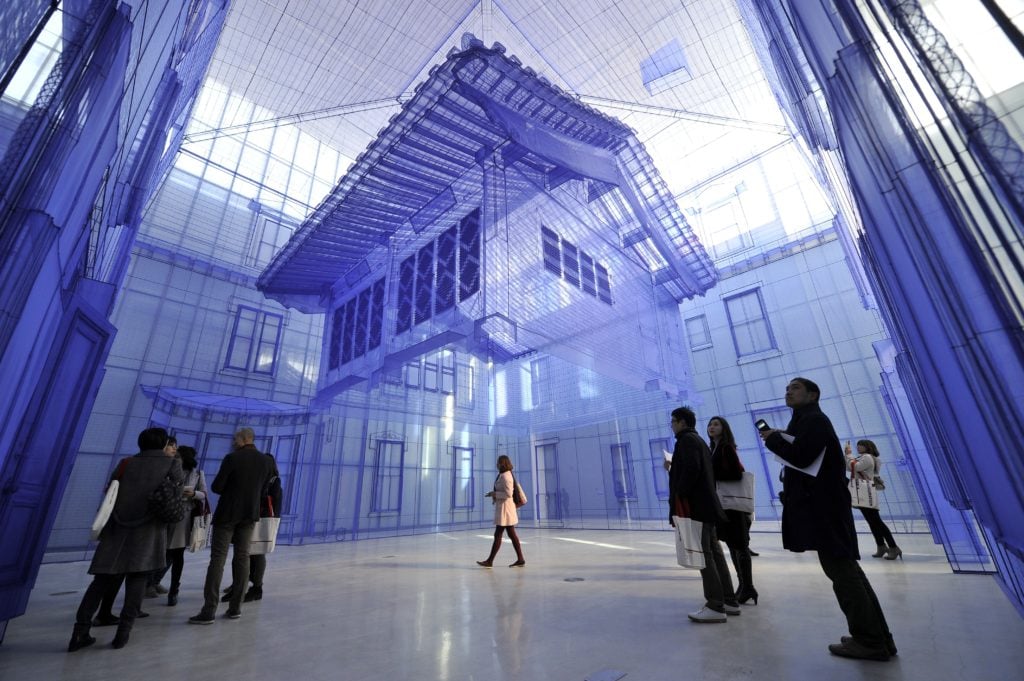 Visitors look at a site-specific art project called "Home within Home" by artist Suh Do-Ho at National Museum of Modern and Contemporary Art, Korea (MMCA) in Seoul. Photo credit should read JUNG YEON-JE/AFP/Getty Images.