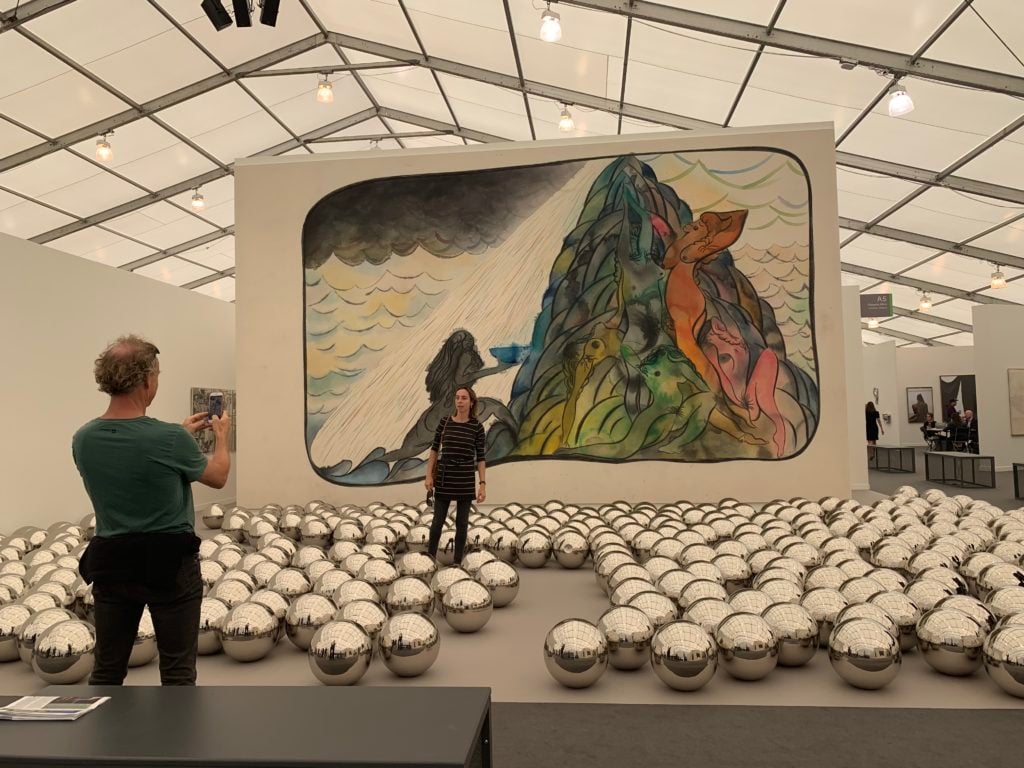 Yayoi Kusama’s Narcissus Garden (1966–) and Chris Ofili’s painting, to take and to give (2012) at Victoria Miro at Frieze New York 2019. Photo by Pac Pobric.