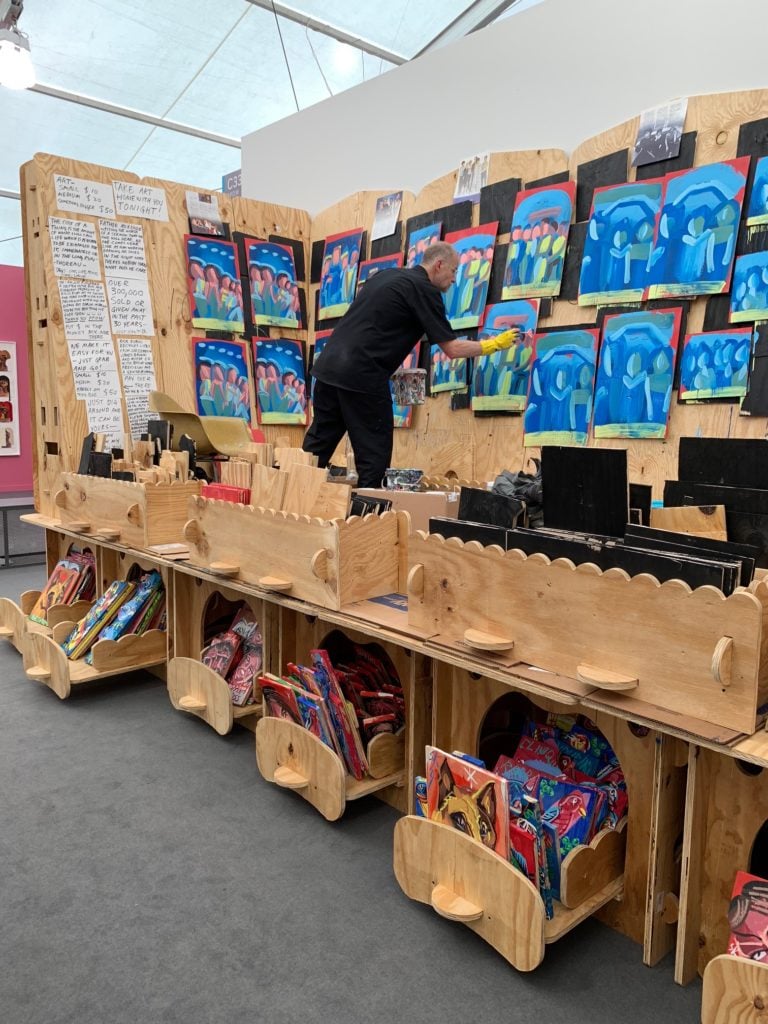 Artist Steve Keene making works at Frieze New York at the PPOW booth, where his pictures were on sale for as little at $10. Courtesy PPOW Gallery.