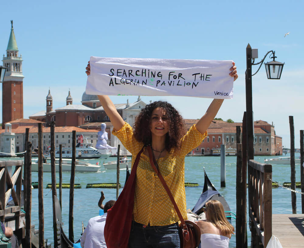 Amina Zoubir. Searching for the Algerian Pavilion (2013). Performance during Venice Biennale. Courtesy of the artist.