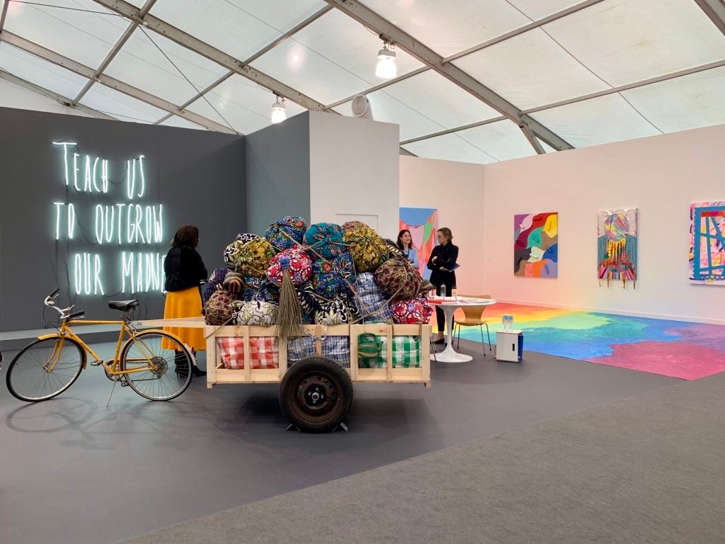 Work by Alfredo Jaar, Barthelemy Toguo, and Sarah Cain from Galerie Lelong at Frieze New York 2019. Photo by Sarah Cascone.