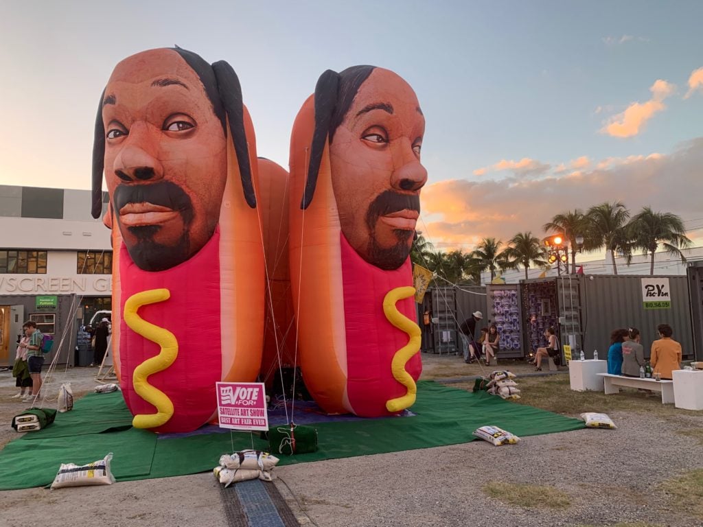SATELLITE ART SHOW took place in a parking lot full of shipping containers in 2018. Cool Shit, <em>Snoop Dogg Hot Dogs</em>. Photo by Sarah Cascone. 