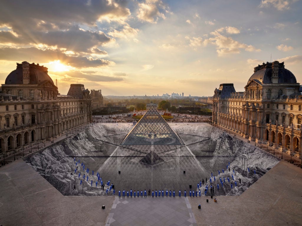 JR's installation at the Louvre in 2019 on the occasion of the pyramid’s 30th anniversary. Photo courtesy of JR-art.net / Perrotin Gallery.