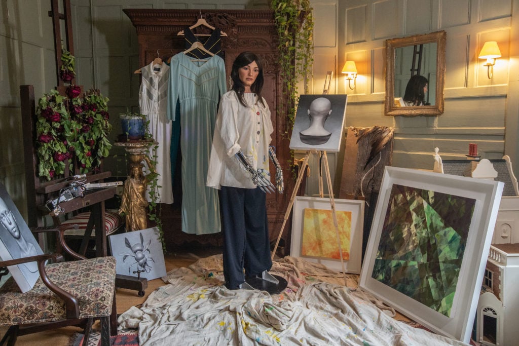 Ai-DA with Her Paintings. Photo by Victor Frankowski.