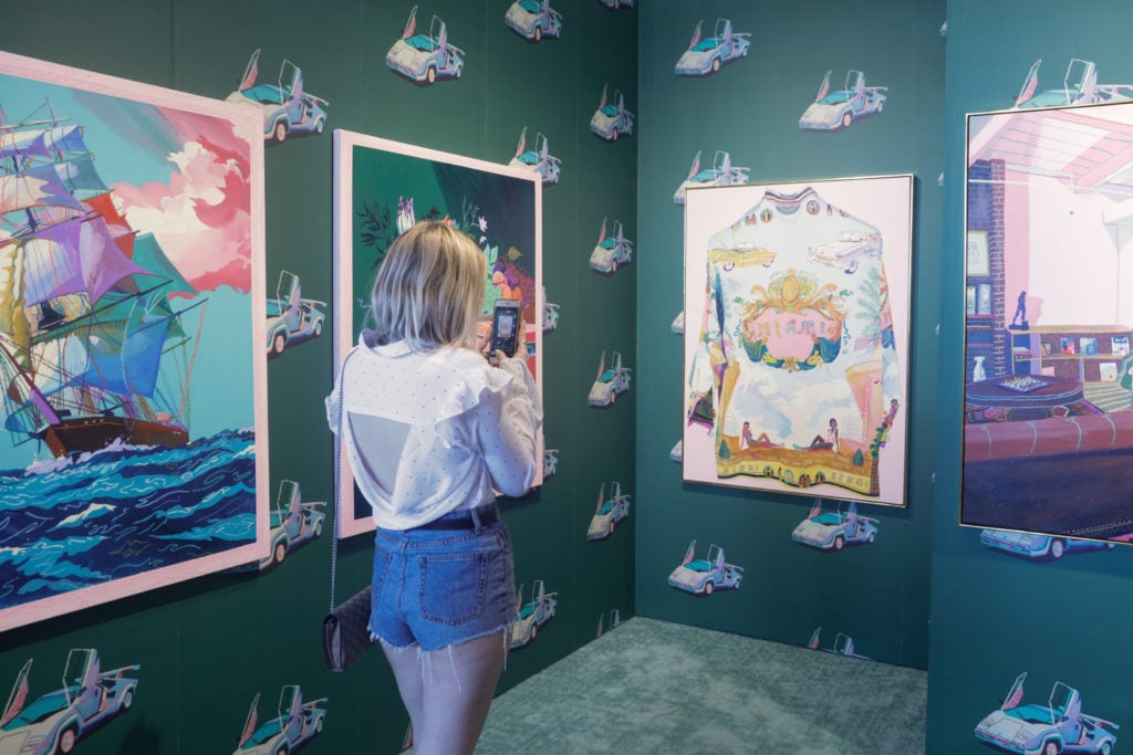 A visitor to the fair captures an Instagram-worthy booth at PULSE, 2018. Courtesy of PULSE Art Fair.
