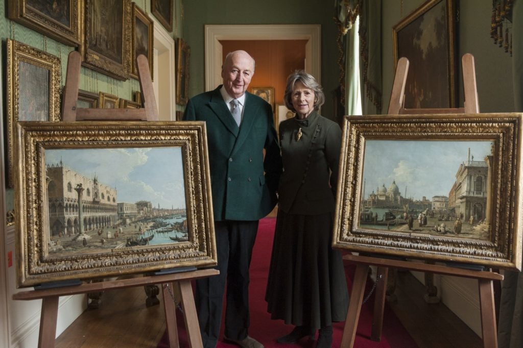 The Duke and Duchess of Devonshire with Canaletto’s <em>Venice: A View of the Doge's Palace and the Riva Degli Schiavoni From the Piazzetta</em> (Shown Left) and <em>Venice: A View of Santa Maria Della Salute and the Entrance to the Grand Canal From the Piazetta</em>. Photo courtesy of Sotheby's.
