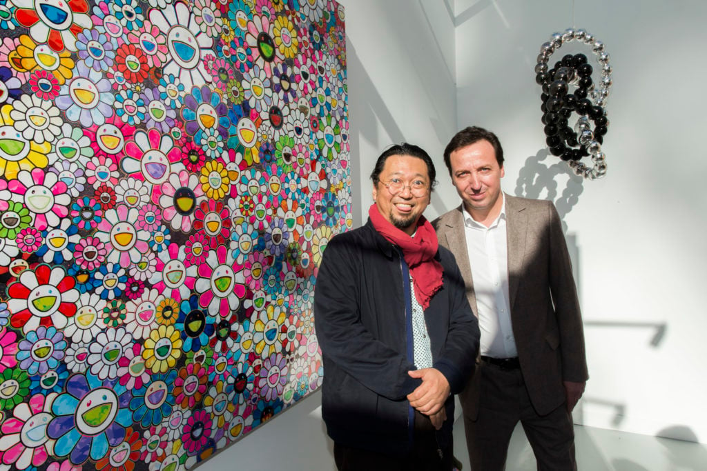 Artist Takashi Murakami and galerist Emmanuel Perrotin attend the opening of the 40th edition of the FIAC International Contemporary Art Fair.(Photo by Bertrand Rindoff Petroff/Getty Images)