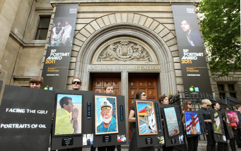Climate activists protest outside the official opening of the BP Portrait Award 2011, at the National Portrait Gallery, in central London. Photo by Dominic Lipinski/PA Images/Getty Images.