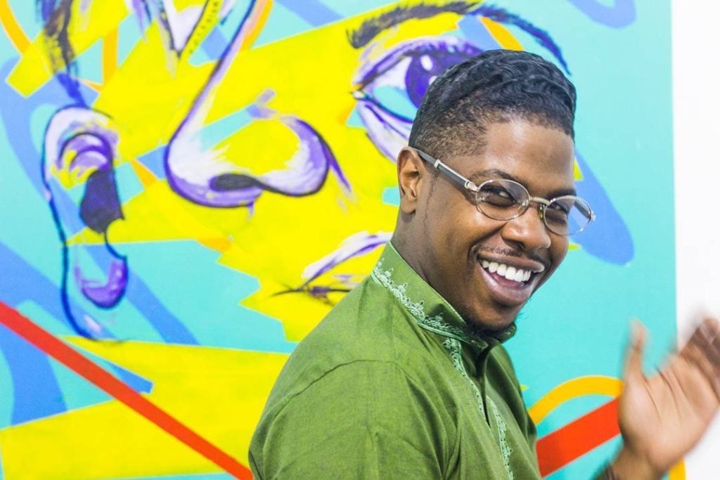 Tashif Turner, also known as Sheefy McFly, in front of one of his murals. Courtesy of the artist.
