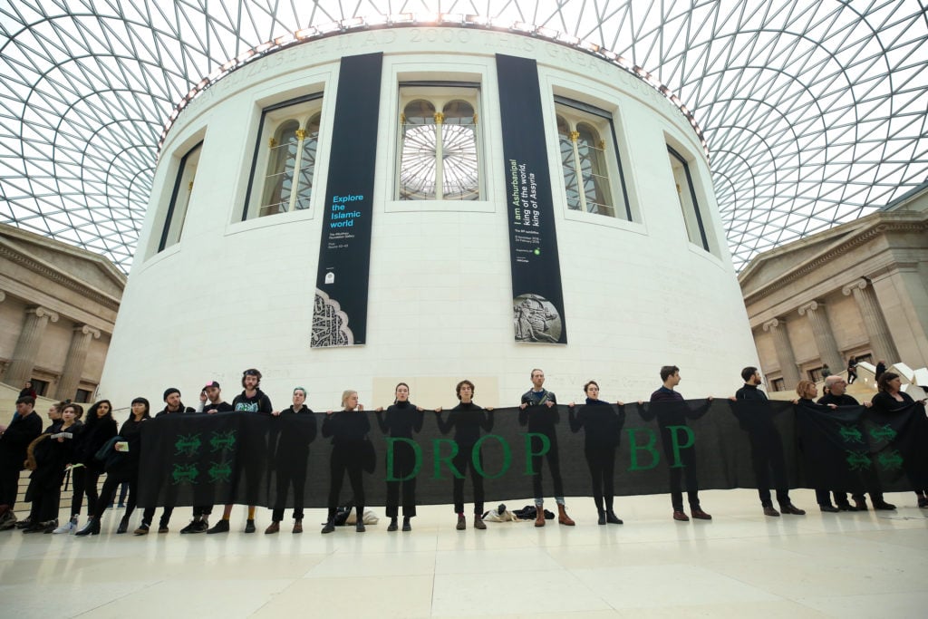 Activists are seen holding a banner during the protest against oil company BP at the British Museum in London, February 2019. Photo: Dinendra Haria/SOPA Images/LightRocket via Getty Images.