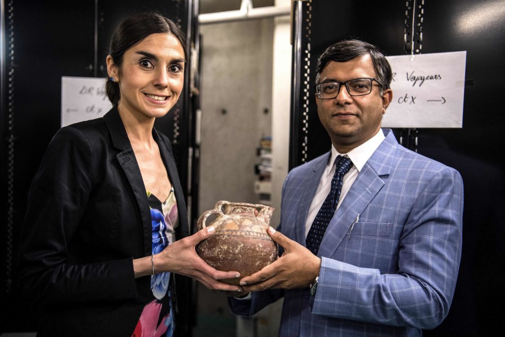 French Customs official Anne-Sophie Vitoux (L) hands over an artifact to a Pakistani embassy official at the Customs department at Roissy airport outside Paris on June 24, 2019. Photo: Christophe Archambault/AFP/Getty Images.