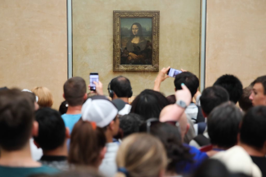 Benefits of Visiting a Museum: Leonardo da Vinci's Mona Lisa at the Louvre Museum, Paris, France. 