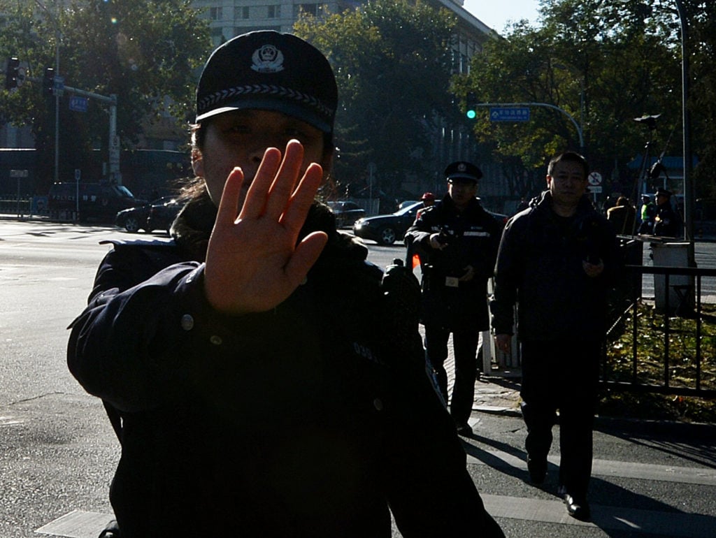 Beijing police. Photo: MARK RALSTON/AFP/Getty Images)
