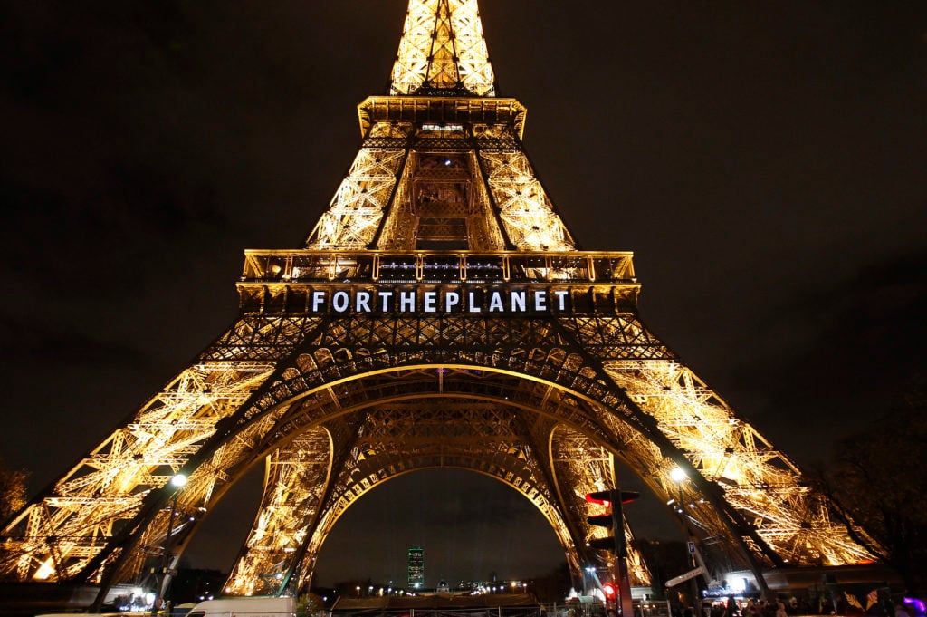 The slogan "For the planet" projected on the Eiffel Tower as part of the World Climate Change Conference 2015 (COP21) on December 11, 2015 in Paris, France. Photo by Chesnot/Getty Images.