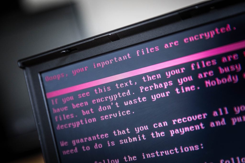 A laptop displays a message after being infected by a ransomware as part of a worldwide cyberattack that hit more than 200,000 victims in more than 150 countries in 2017. Photo AFP PHOTO/ANP/Rob Engelaar/Netherlands /Getty Images.