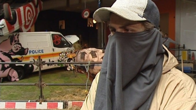 A young man who identified himself as Banksy was interviewed on camera and filmed creating known works by the anonymous British street artist at his first major show 
