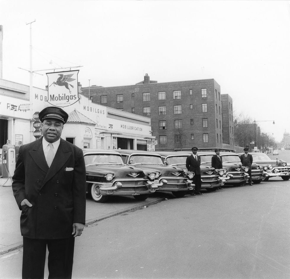 Bertrand Miles, Roosevelt Zanders poses with the fleet of limousines he uses in his New York livery service, 1956. Photo courtesy of Johnson Publishing Company.