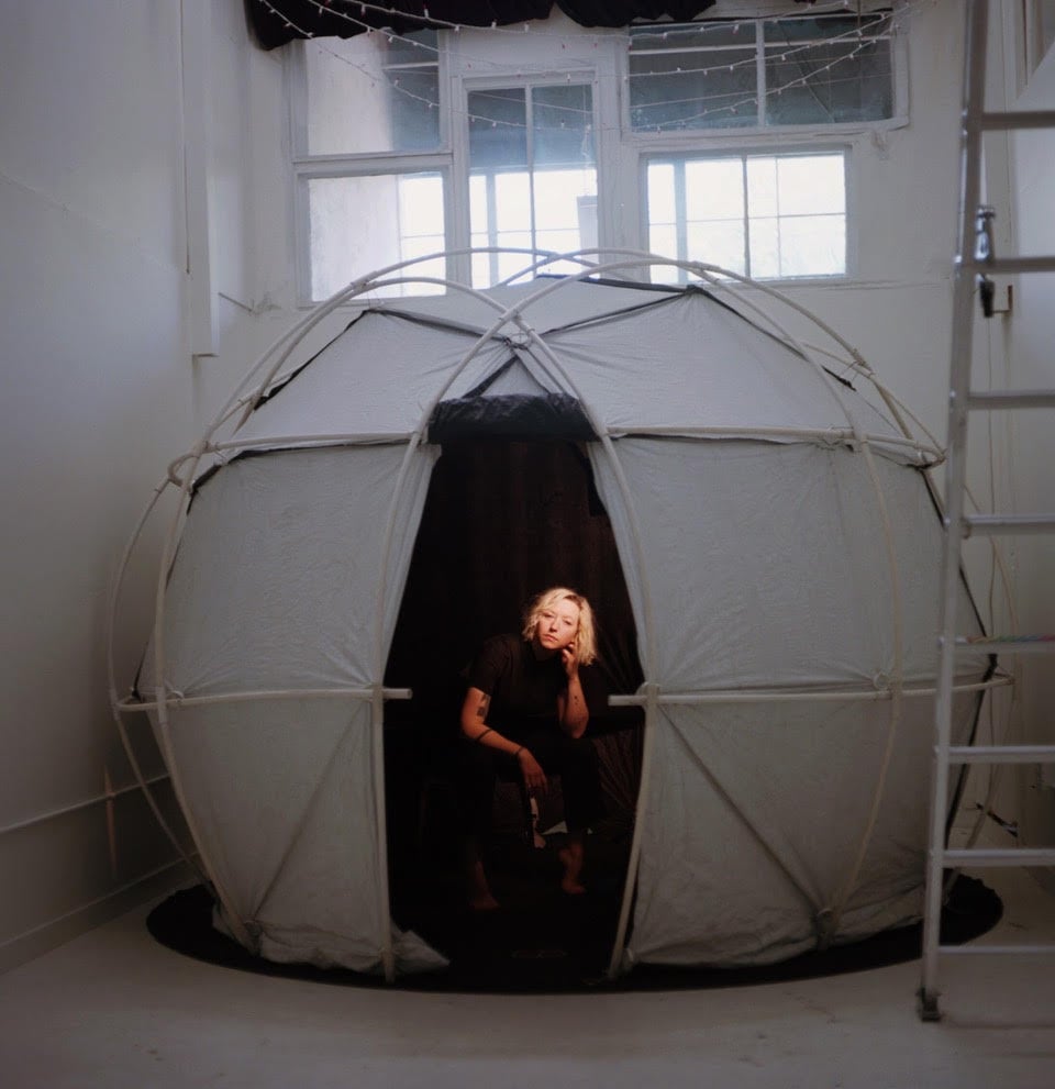 Artist Christina Lonsdale in the tent she uses to photograph subjects—and their auras—for her portrait practice Radiant Human. Photo by Brandon Black.