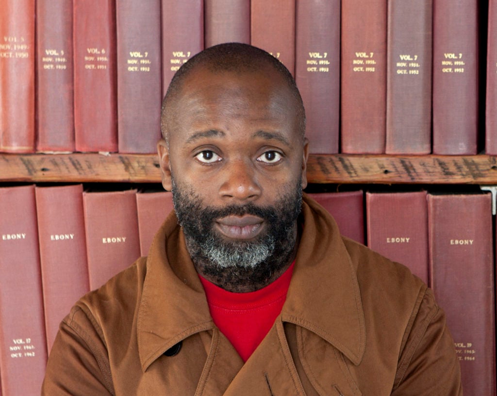 Theaster Gates with part of the Johnson Publishing Archive. Photo by Sarah Pooley, courtesy of the artist.