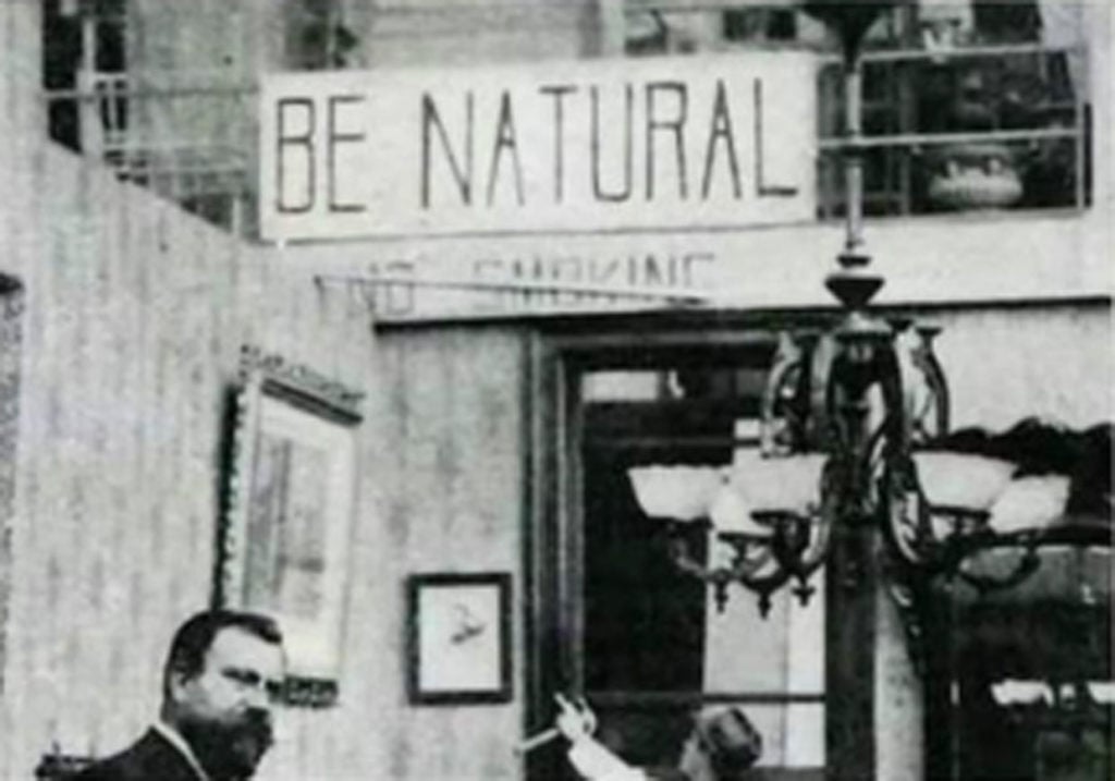The "Be Natural" sign in Alice Guy-Blaché's Solax studio, as seen in the documentary <eM>Be Natural: The Untold Story of Alice Guy-Blaché</em>. Courtesy of Zeitgeist Films/Kino Lorber.