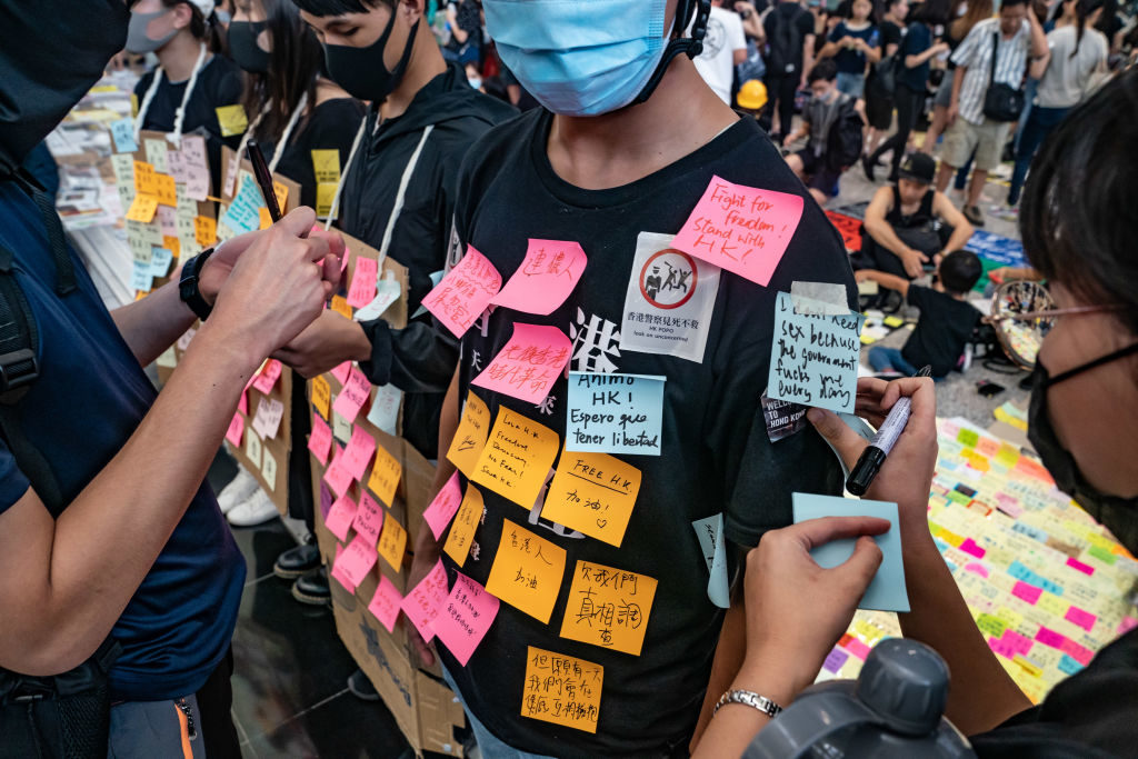 Protesters stick memo notes on a "Human Lennon Wall" at the arrival hall of the Hong Kong International Airport during a demonstration on August 11, 2019 in Hong Kong, China. Photo by Anthony Kwan/Getty Images.