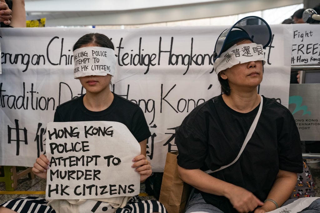 Protesters occupy the arrival hall of the Hong Kong International Airport during a demonstration on August 12, 2019 in Hong Kong, China. Photo by Anthony Kwan/Getty Images.