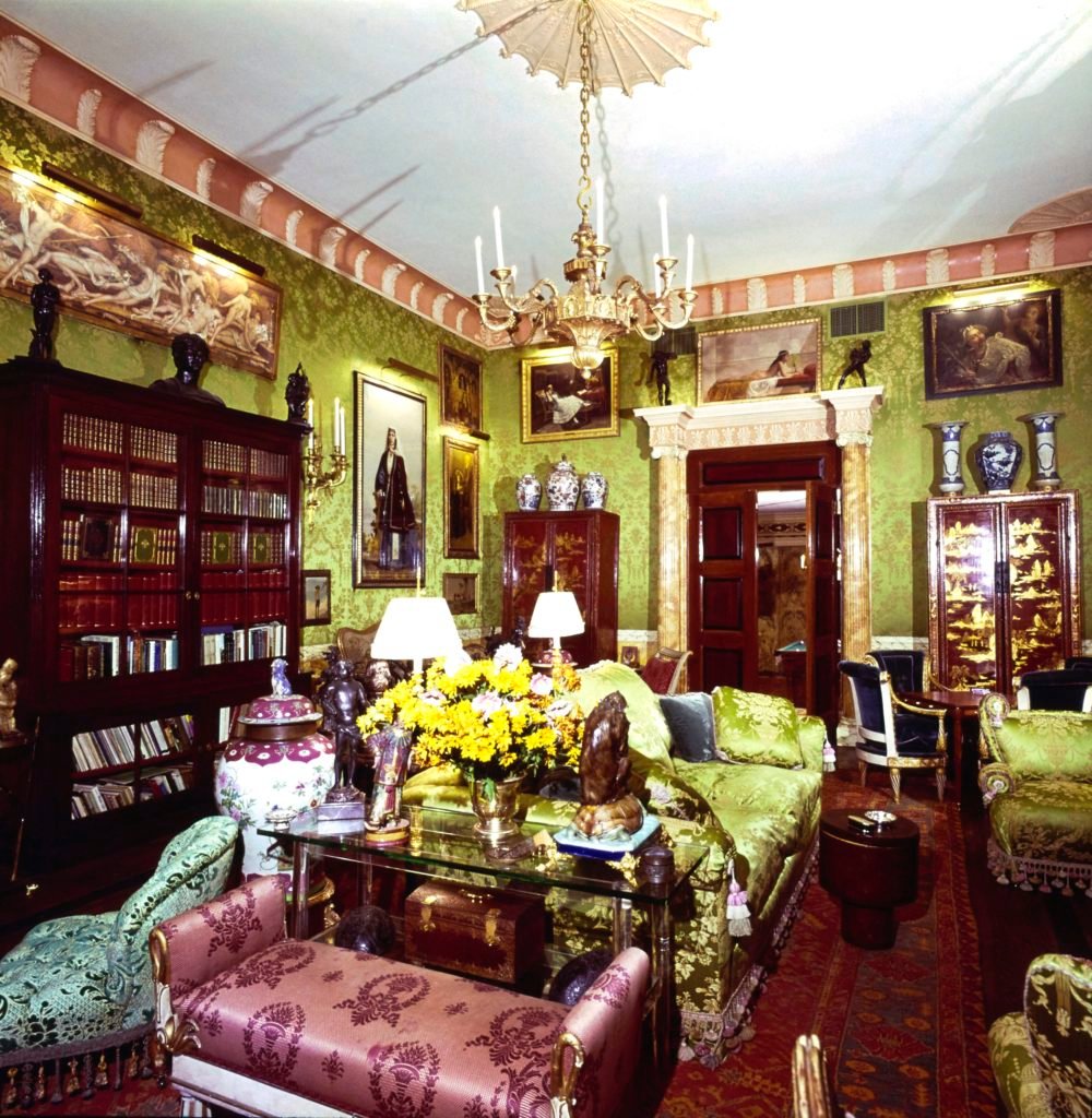Vogue, February 01, 1977 - A reverse view of the living room of the Upper East Side, New York, New York, apartment of Robert Denning and Vincent Fourcade, owners of the interior designer firm Denning & Fourcade, Inc. The style of the 40' long x 25' wide x 15' tall ornate room is described as a 