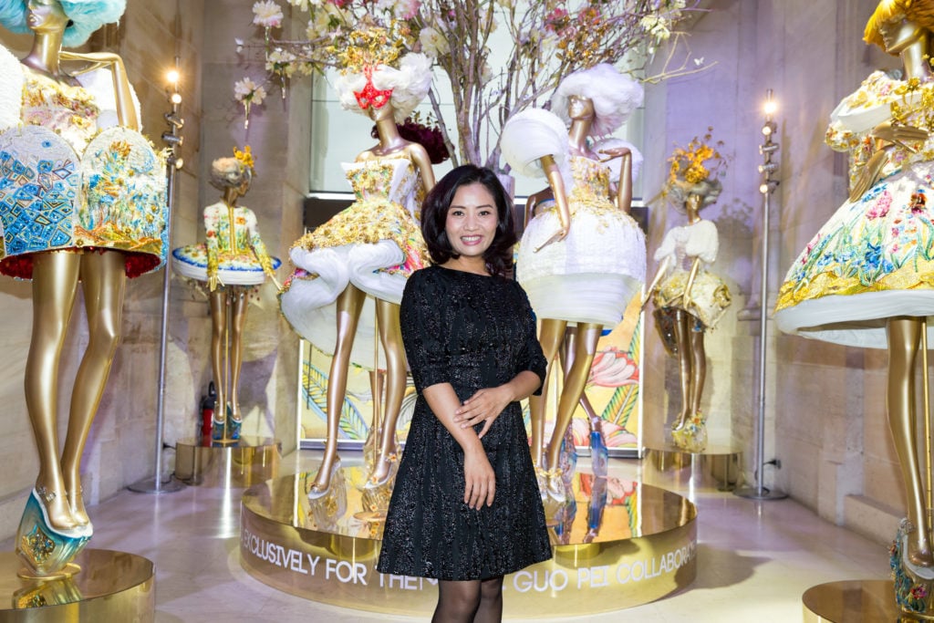 Designer Guo Pei poses with her work during an event at Paris's Musee Des Arts Decoratifs in Paris in 2015. (Photo by Richard Bord/GettyImages for Mac Cosmetics)