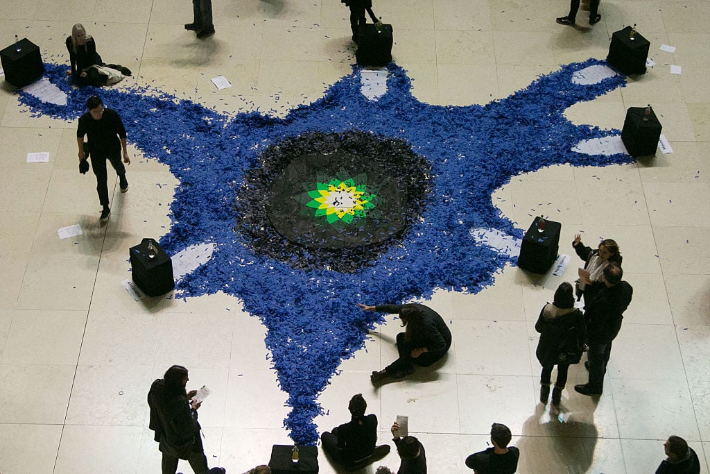 The artist activist group Bp-or-not-Bp stage a ceremonial performance at the British Museumin 2016. Photo by Kristian Buus/In Pictures via Getty Images Images.