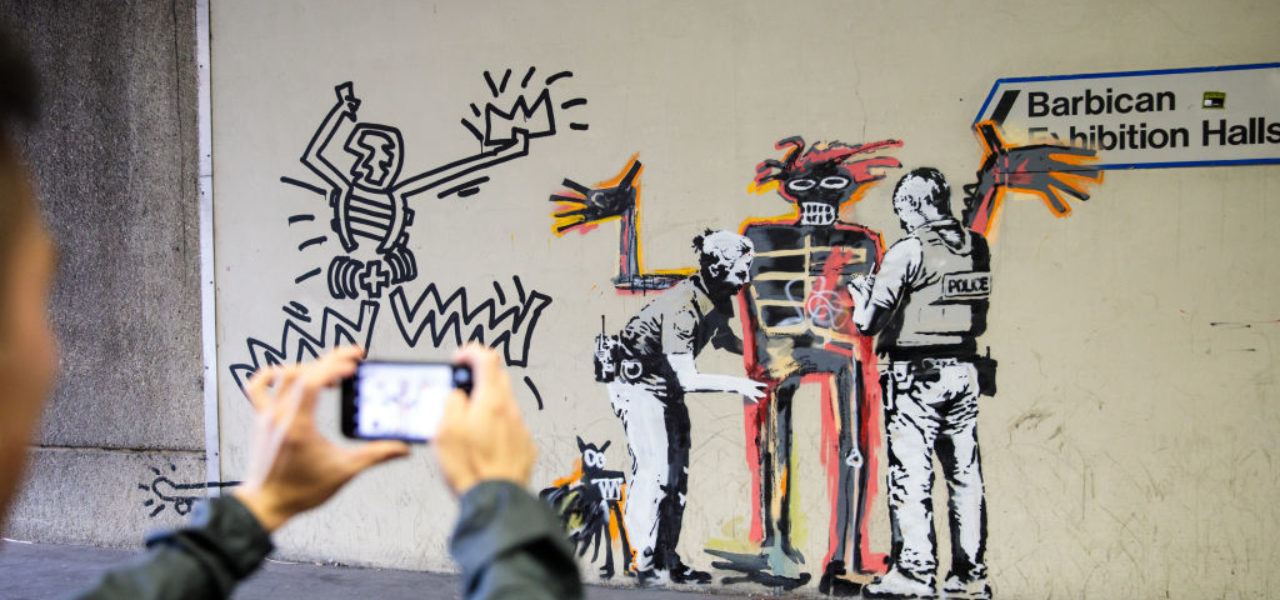 Street artist Banksy's riff on the Basquiat exhibition "Boom for Real" at London's Barbican Gallery, 2017. Photo by Jack Taylor/Getty Images.