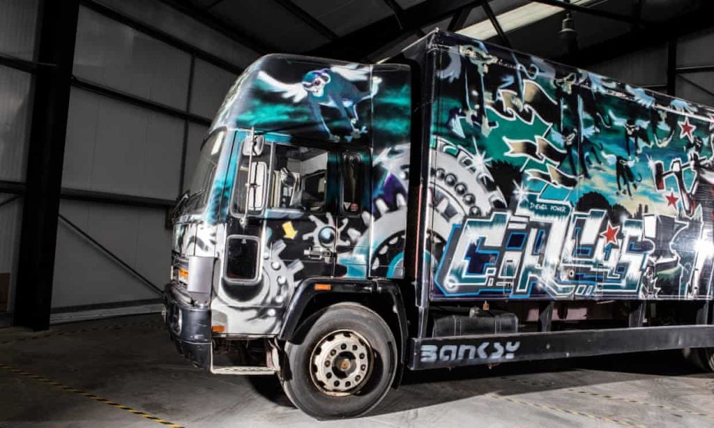 Banksy, <em>Turbo Zone Truck (Laugh Now But One Day We’ll Be in Charge)</em>, 2000. The work carries a pre-sale estimate of £1 million–1 million ($1.3 million–2 million) for its upcoming sale at Bonhams' Goodwood Revival car auction. Photo courtesy of Bonhams. 