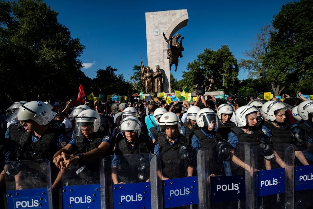 Turkish anti-riot police officers stand guard as demonstrators gather on July 27, 2019, in Istanbul to support refugees and demonstrate against the Turkish government's recent refugee action. Photo by Yasin Akgul/AFP/Getty Images.