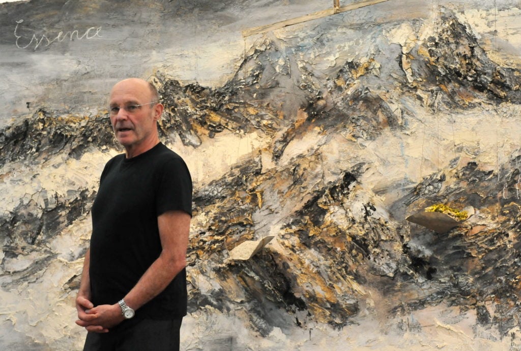 German painter and sculptor Anselm Kiefer poses in front of his work. Photo: Rolf Haid/AFP/Getty Images.