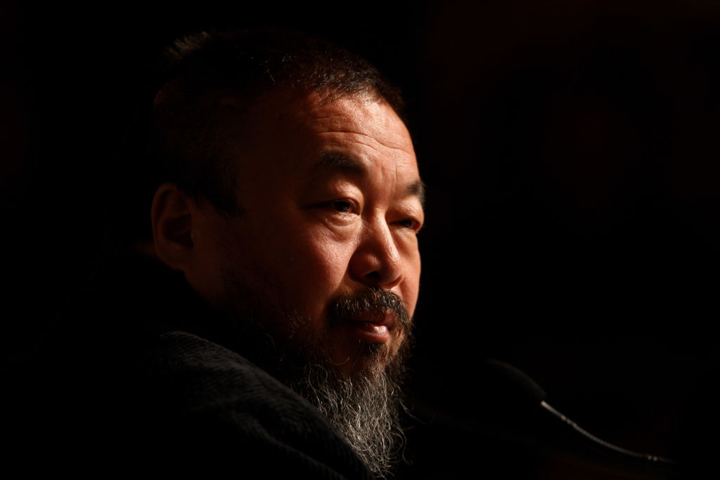 Ai Weiwei, one of China's most controversial artists, looks on during his solo exhibition "So Sorry" at Haus der Kunst in 2009. Photo by Miguel Villagran/Getty Images.