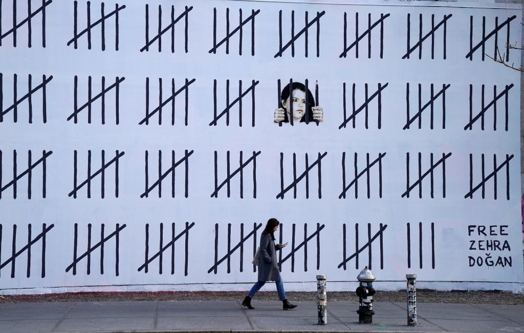 An artwork by Banksy in New York drawing attention to the imprisonment of Zehra Dogan, a Kurdish painter from Turkey. Photo by Timothy A. Clary/AFP/Getty Images.