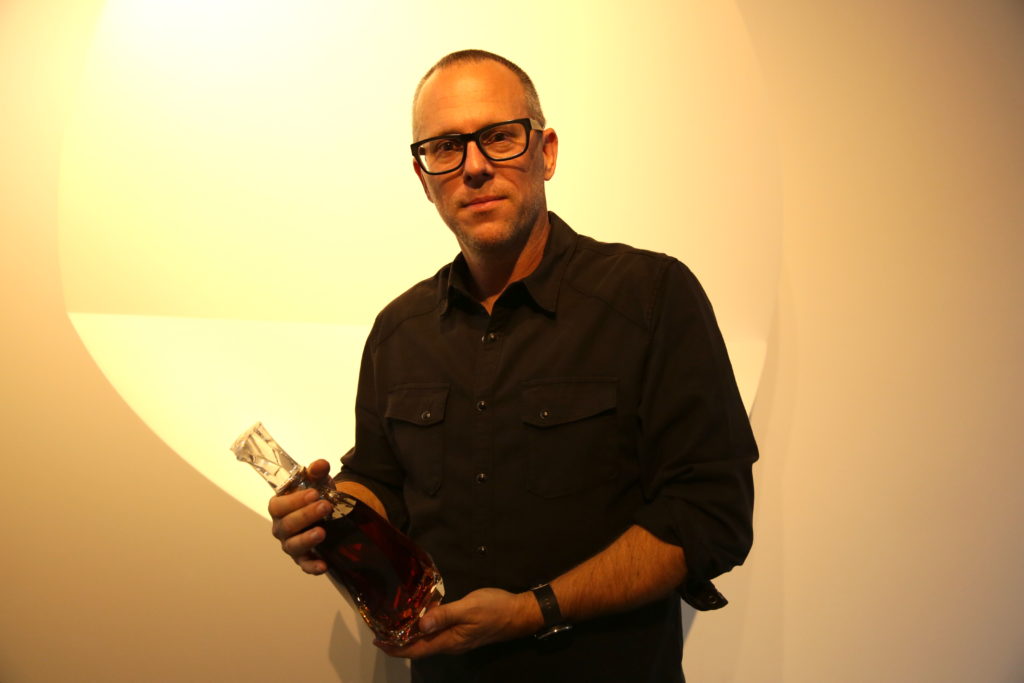 Phillip K. Smith with a bottle of Hennessy Paradis Imperial. Photo courtesy artnet.