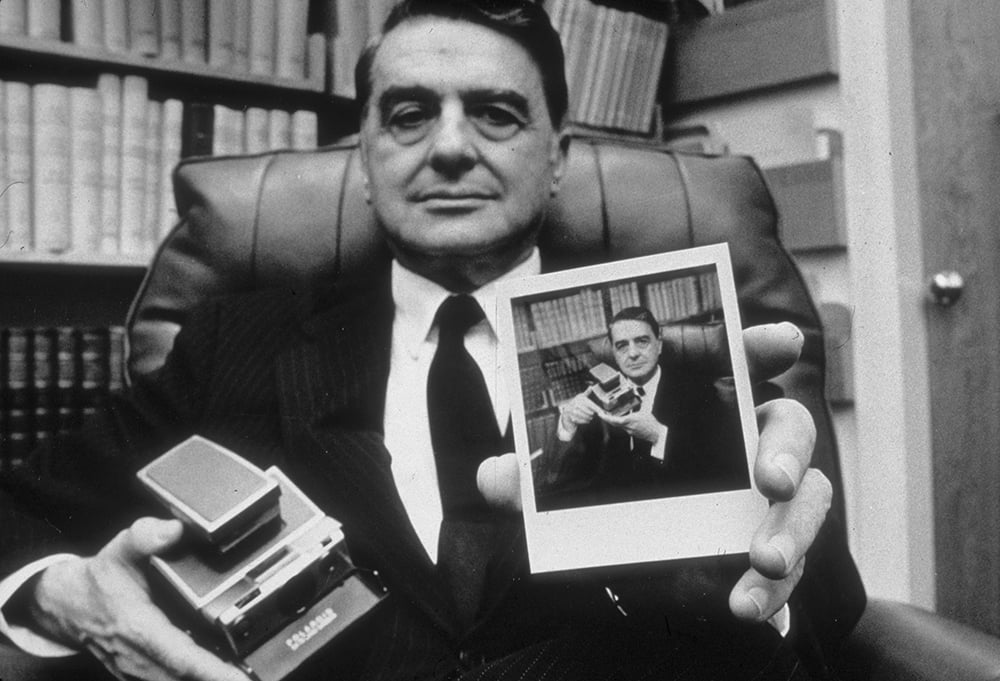 Edwin Land, inventor of instant photography, holds a Polaroid SX-70 camera and photograph. Photo by Joyce Dopkeen/Archive Photos/Getty Images.