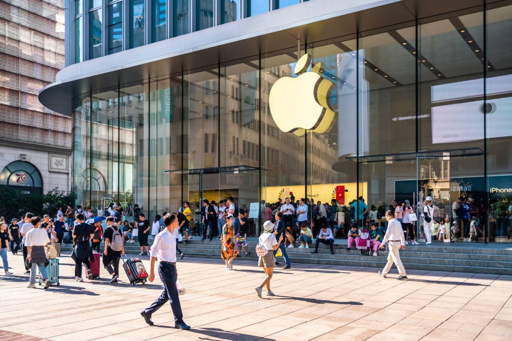 Pedestrians walk past an Apple store on East Nanjing Road in Shanghai. (Photo by Alex Tai/SOPA Images/LightRocket via Getty Images)